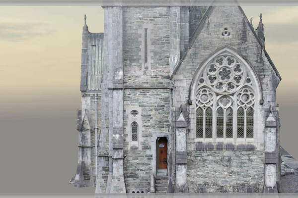 Exterior detail of the Gothic chapel, showcasing a large arched window with intricate tracery and a smaller wooden door below.